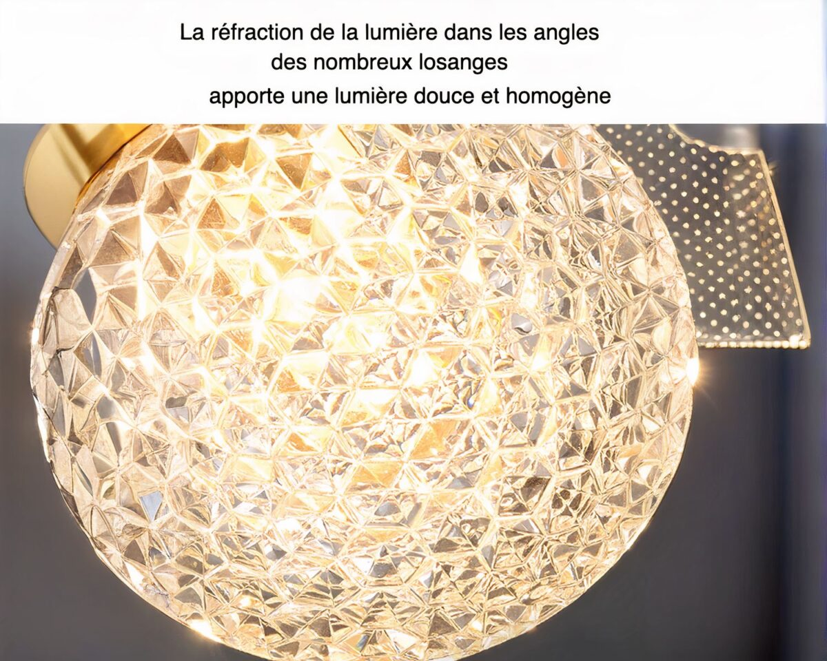 Photo d'un luminaire salle de bain doré en forme de fleurs à gros coeur et pétales légers transparents, le tout sur un fond gris foncé