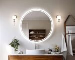 Miroir circulaire LED au-dessus d'une vasque.