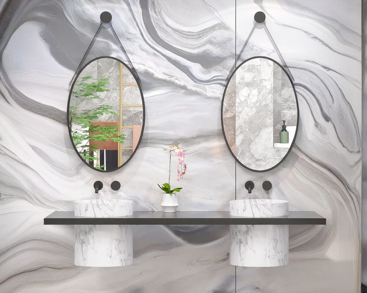 Miroirs ovales suspendus au-dessus de deux vasques.