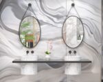 Miroirs ovales suspendus au-dessus de deux vasques.