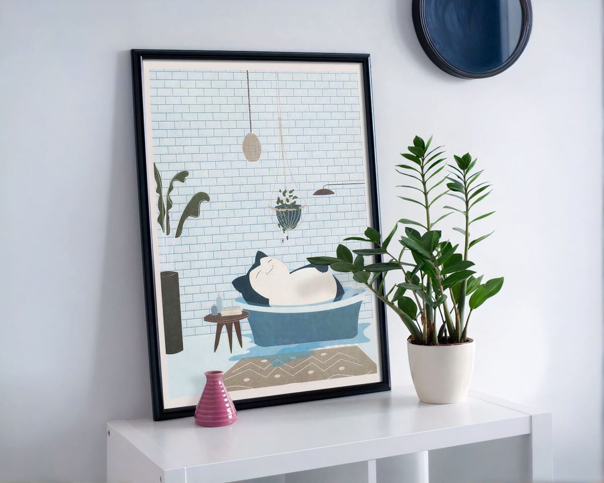 Tableau posé sur un meuble avec une plante.